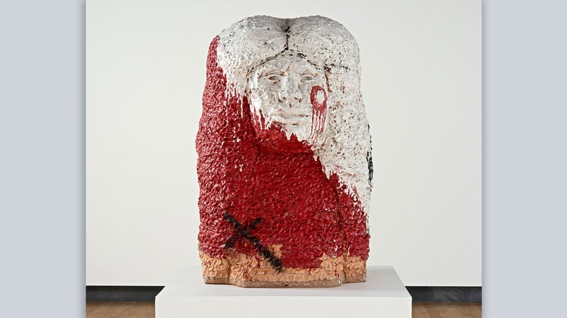A white and red glazed stoneware figure.