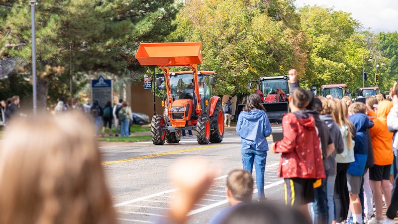Tractors driving in a parade.
