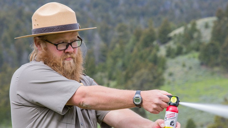 A ranger demonstrating the use of bear spray.