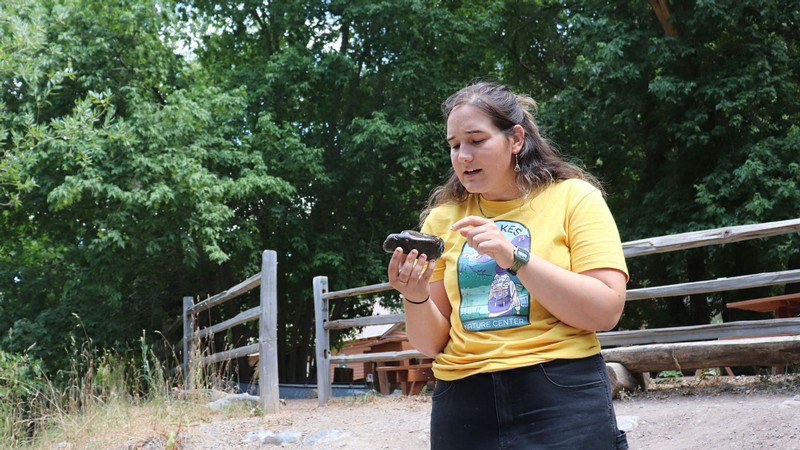 Kate Hunter holding a rock.