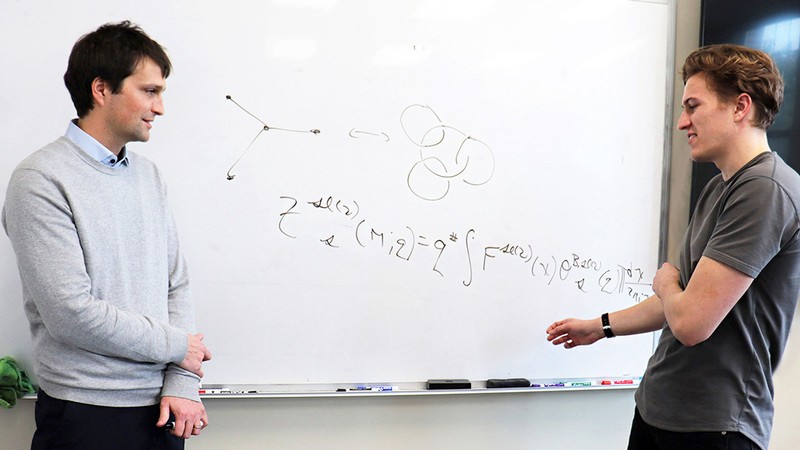 USU mathematicians at a whiteboard.