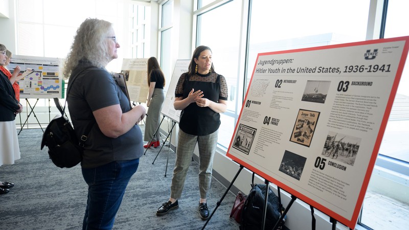 People discussing a research poster.