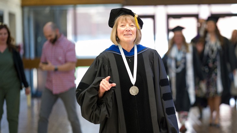Nancy Glomb in graduation robes.