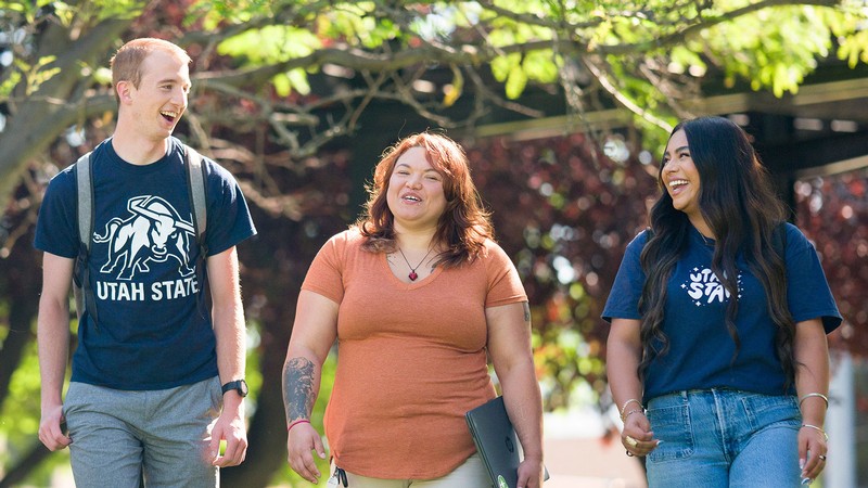 Students walking on a sidewalk.