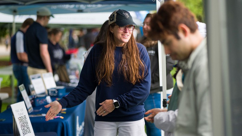 A person staffing an info booth.