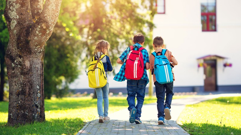 Children walking on a sidewalk.