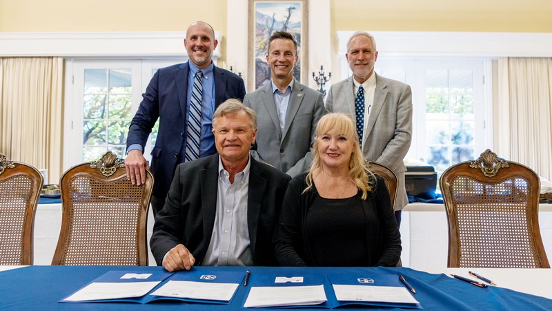 People at a signing ceremony.