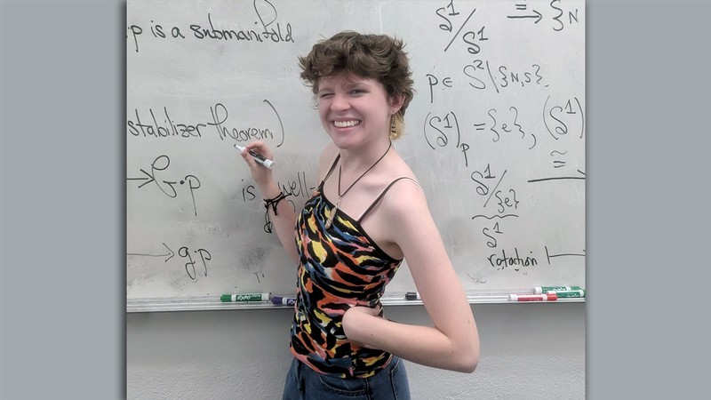 India Evans at a whiteboard.