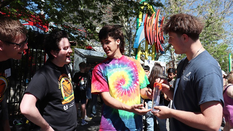 Four young people at an amusement park.