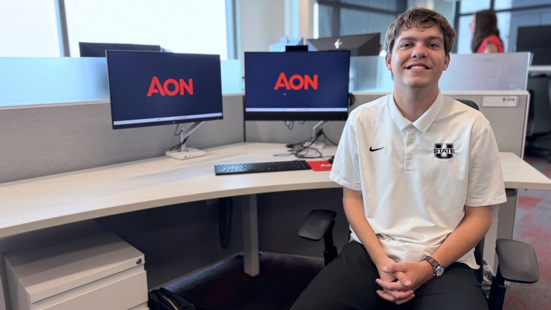 USU actuarial science student Briggs Rober at an office computer.