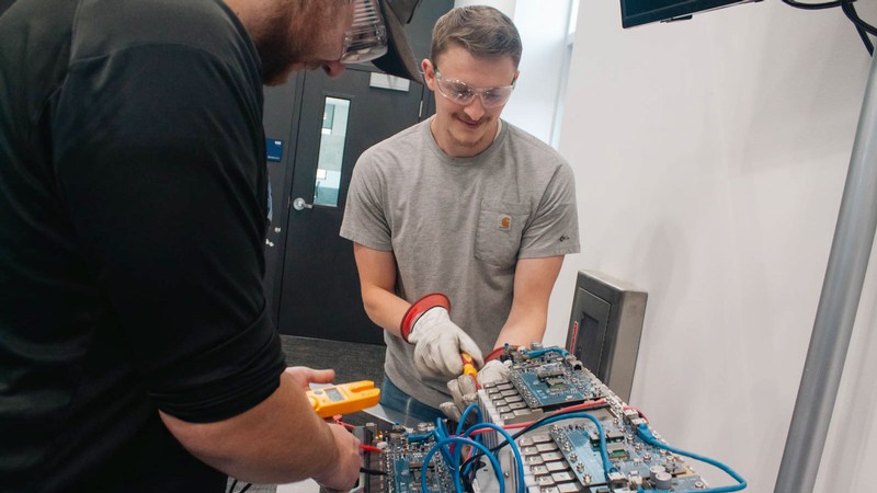 People working on an electric vehicle battery.