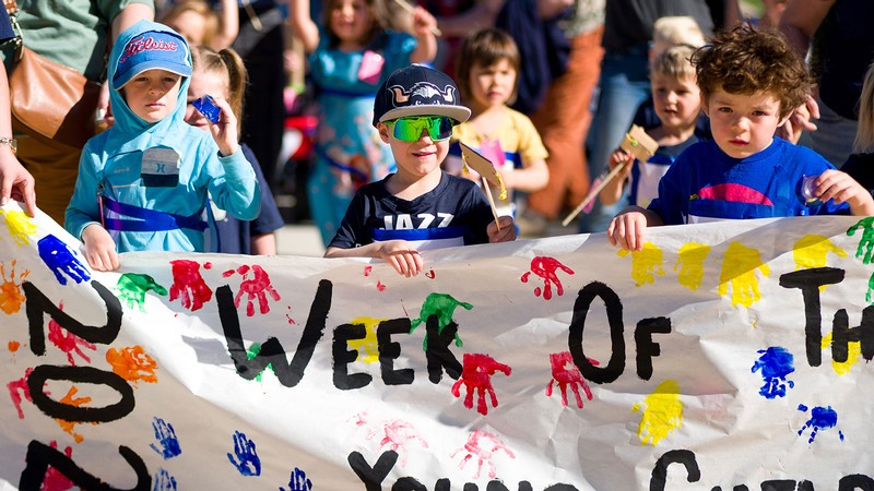 Children marching in a parade.
