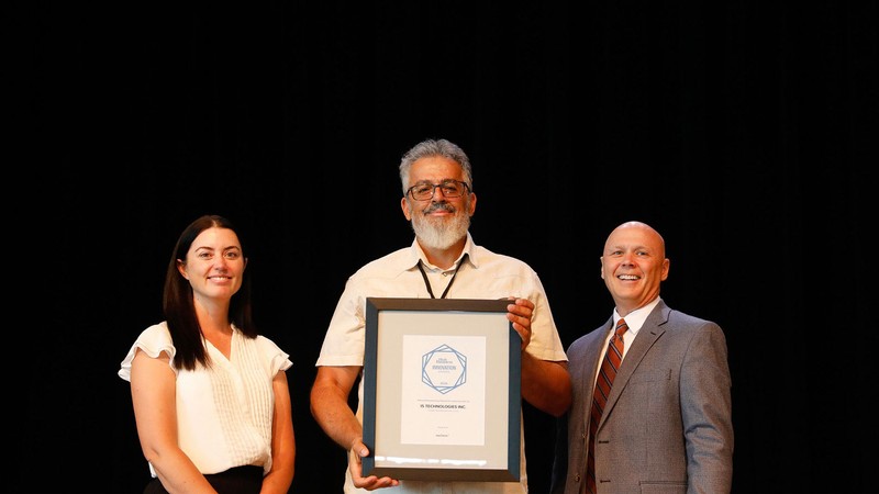 People standing with an award certificate.