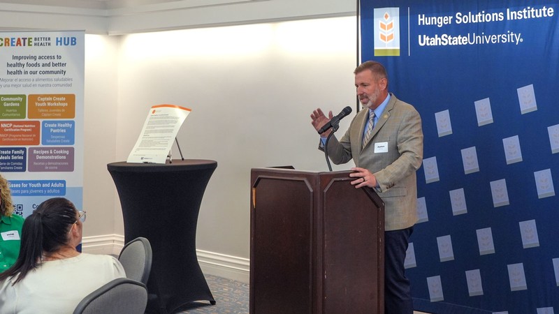 Justen Smith speaking at an event.
