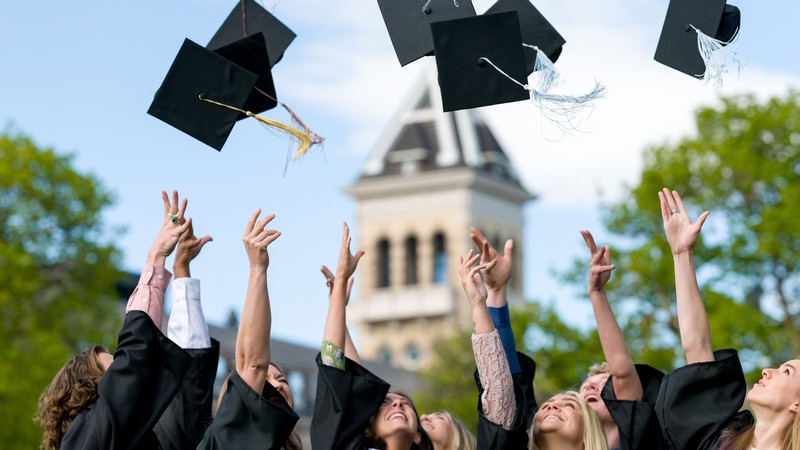 Graduates throwing their hats in the air.