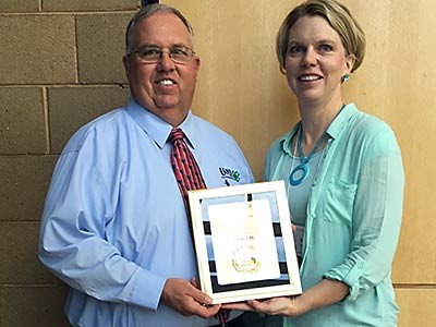 USU Extension specialist receiving an award on behalf of the Utah 4-H program