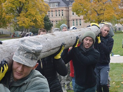 AFROTC students lifting logs