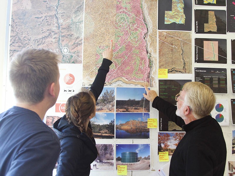 student looking at landscape drawings