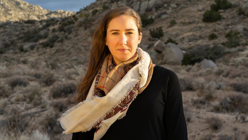 A photo of Evey Gannaway Dalton at the basin of a mountain.