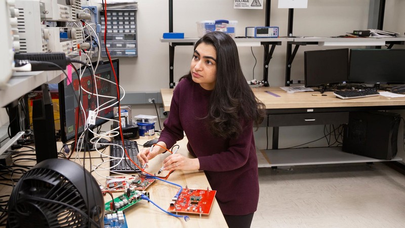 Marium Rasheed tests electronic equipment in a laboratory at Utah State University.