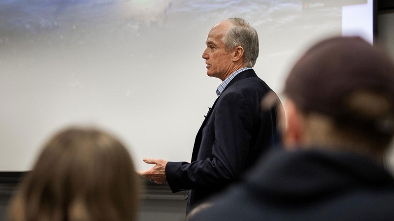Former astronaut Charlie Precourt delivers a lecture.