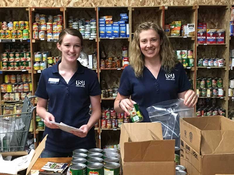 two USU students in the food bank