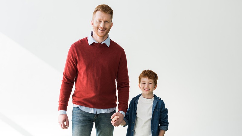 Father and son pose for a picture.