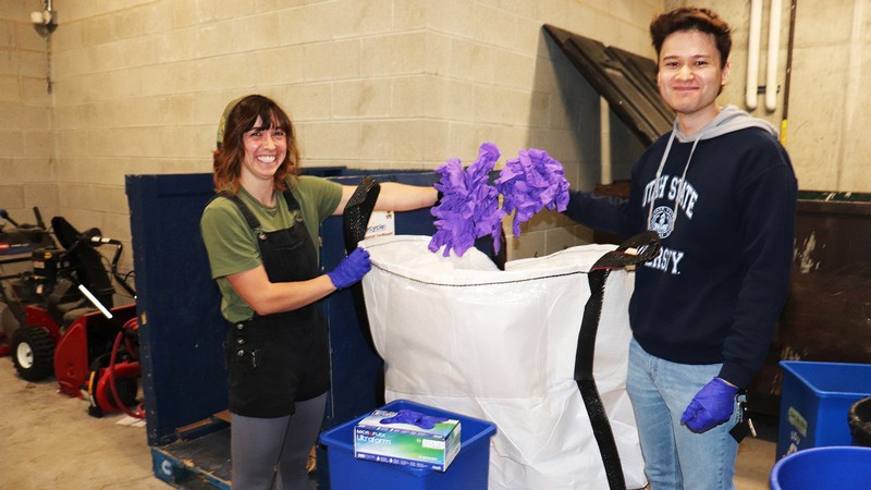 Students deposit lab gloves into container
