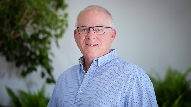 A man poses for a headshot.
