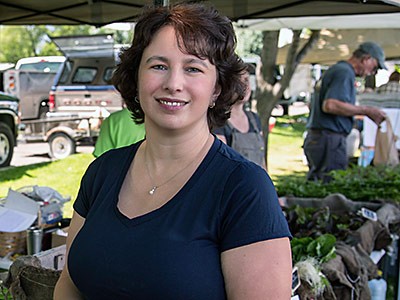 Kynda Curtis at an outdoor market with locallly produced produce