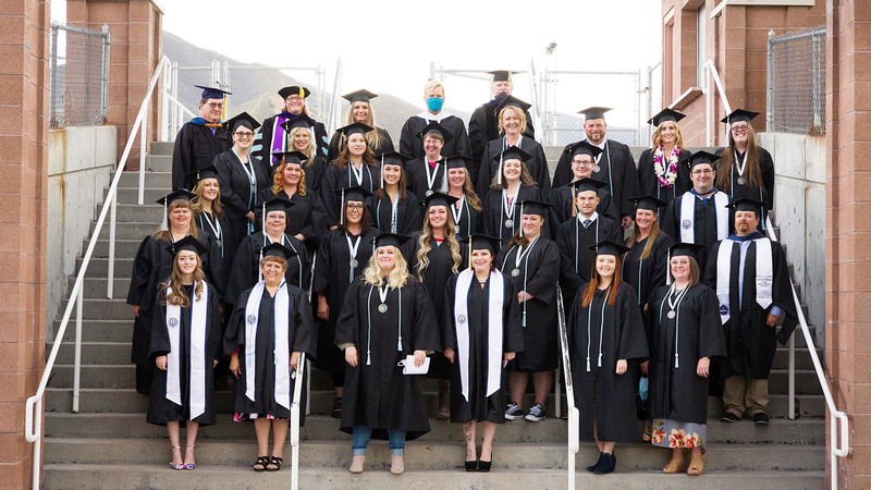 The 2021 class poses for a photo in their regalia.