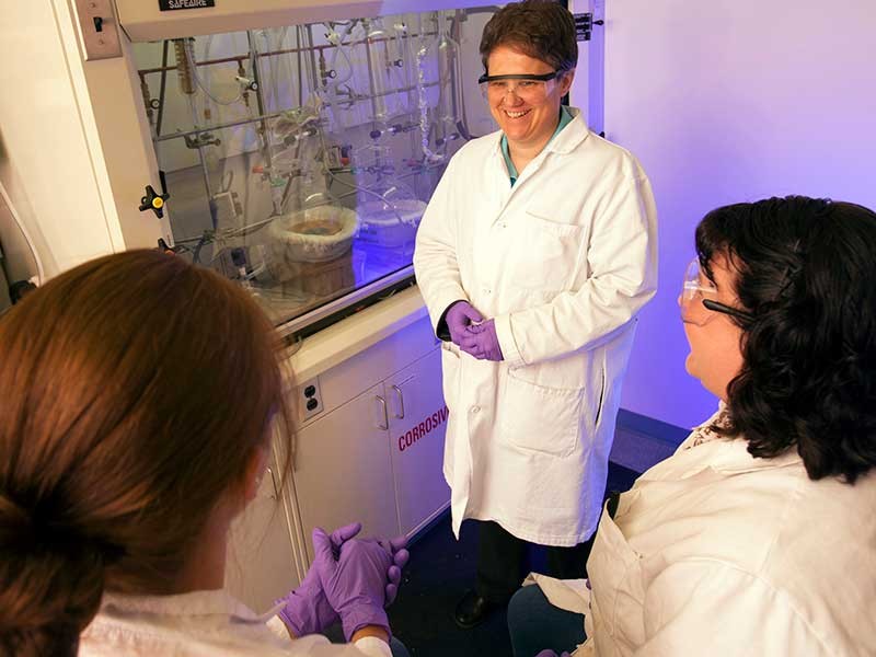 Chemist Lisa Berreau in lab with students