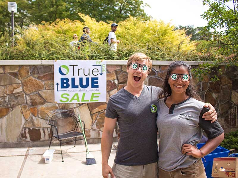 Two students with sustainability council poster