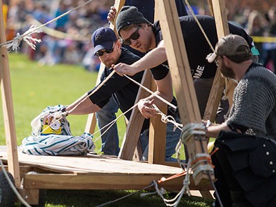 students with a trebuchet or 'pumpkin launcher'