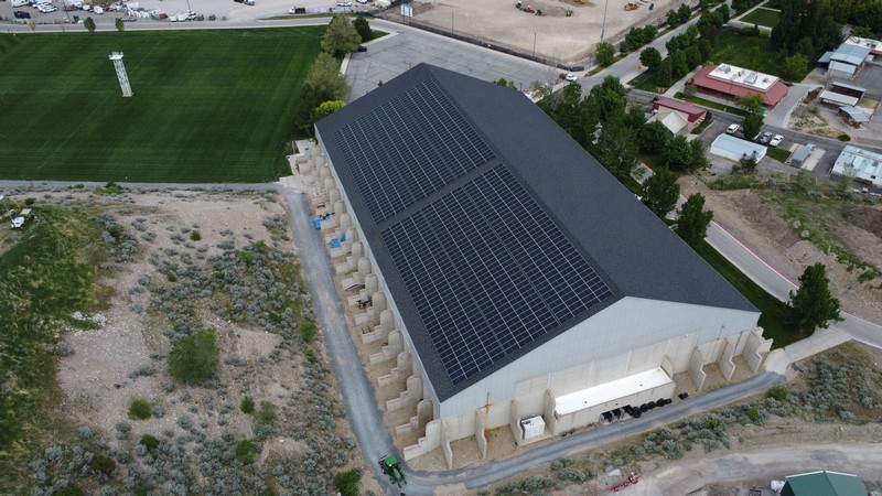 Solar panels on the roof of an indoor athletic training facility.