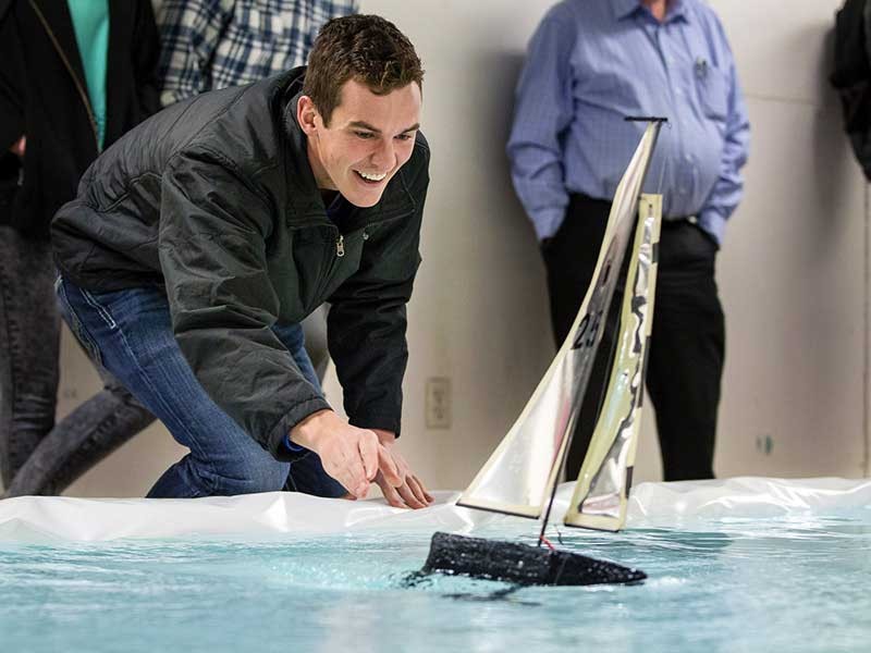 USU students racing radio-controlled sailboats