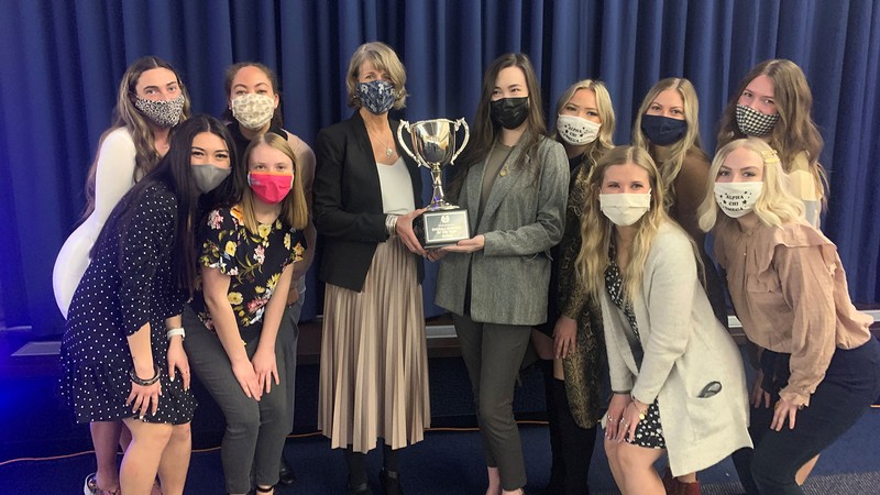 USU President Noelle Cockett (center left) poses with Alpha Chi Omega chapter members.
