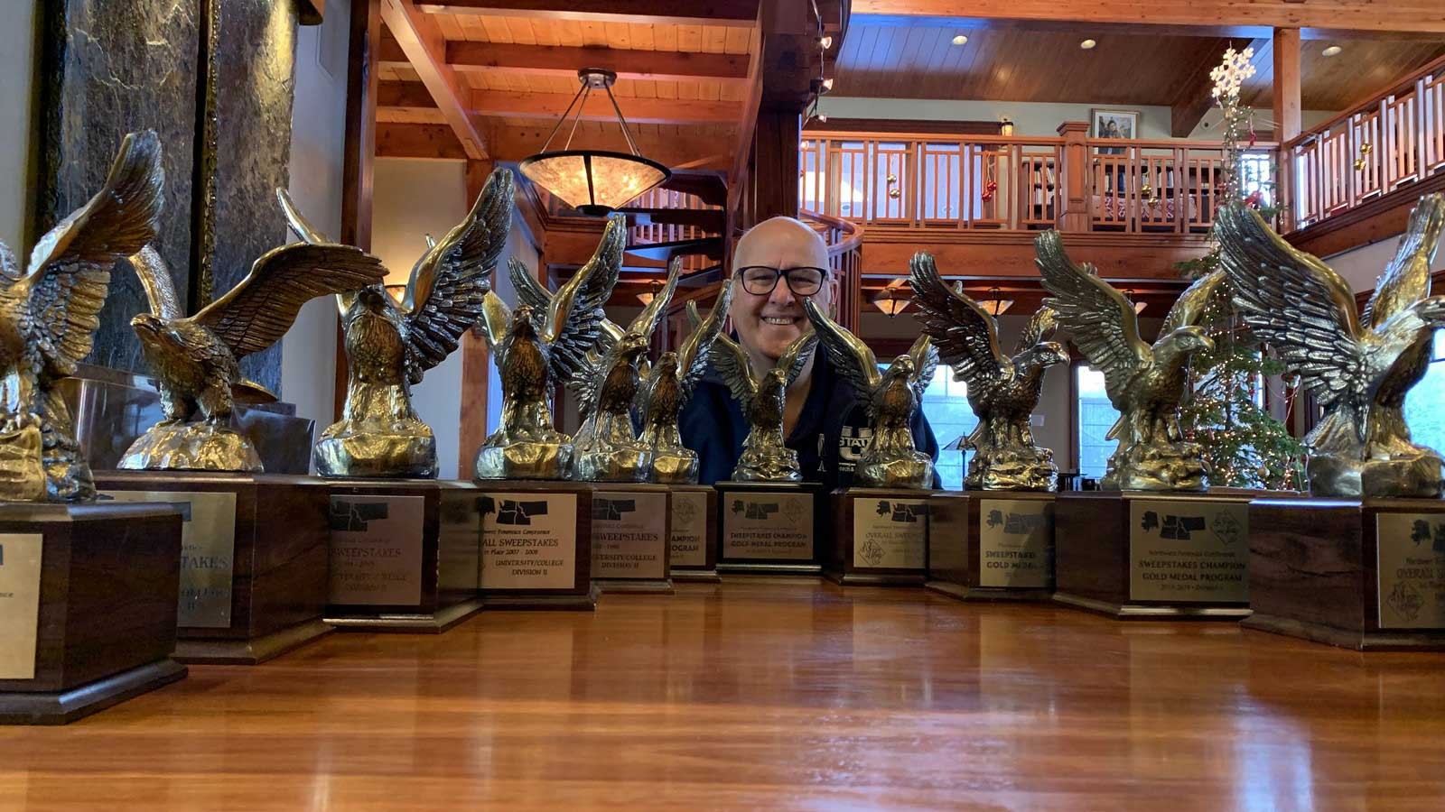 Tom Worthen with the Speech and Debate trophies
