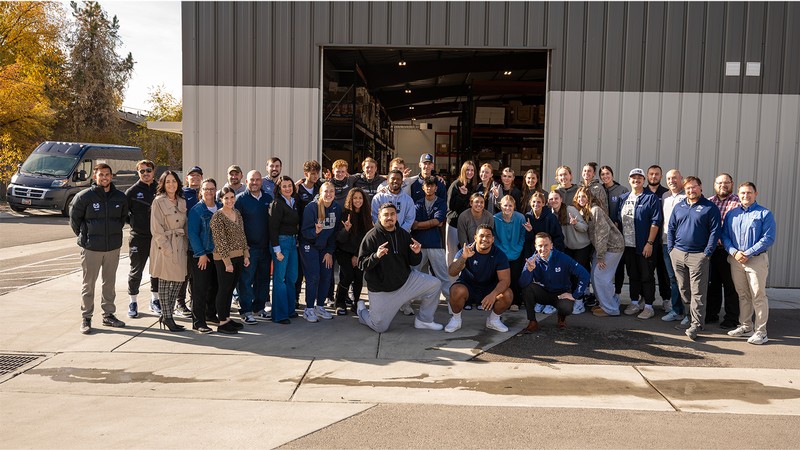 Alta Bank, USU Aggies and community members pose for photo at local food bank