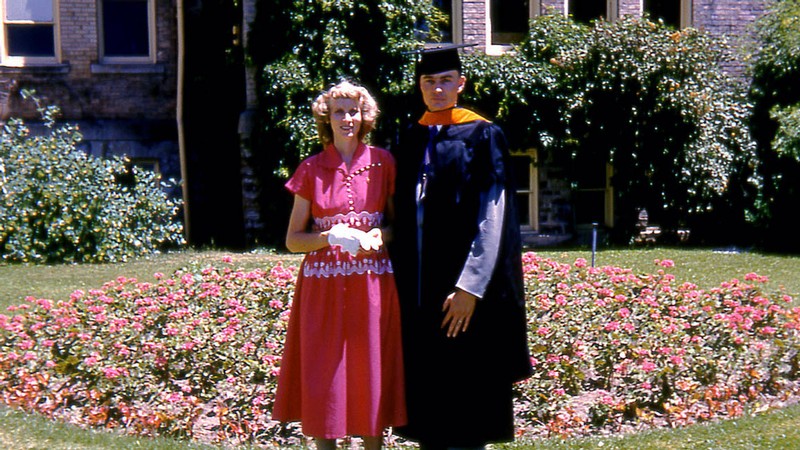 Day with his wife, Zella, after graduating with his master’s from USU.