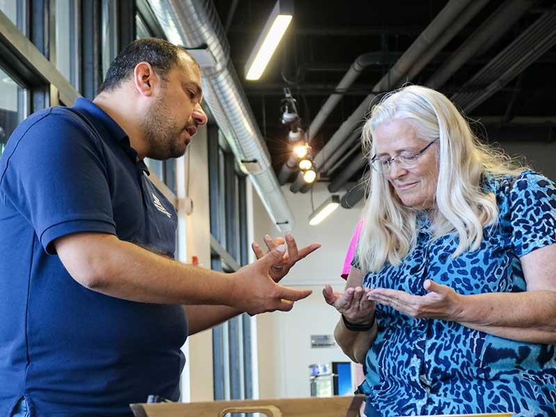 A USU food science student teaching a guest