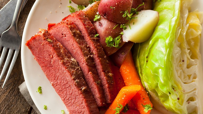 Corned beef and cabbage meal with carrots.
