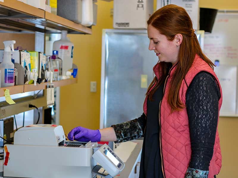 Graduate student Laura Moley with cloning equipment