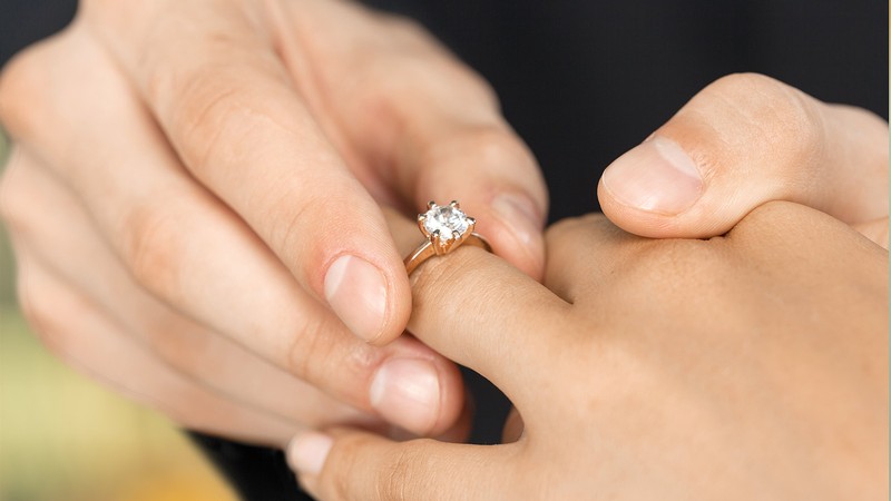 Engagement ring on a ring finger.