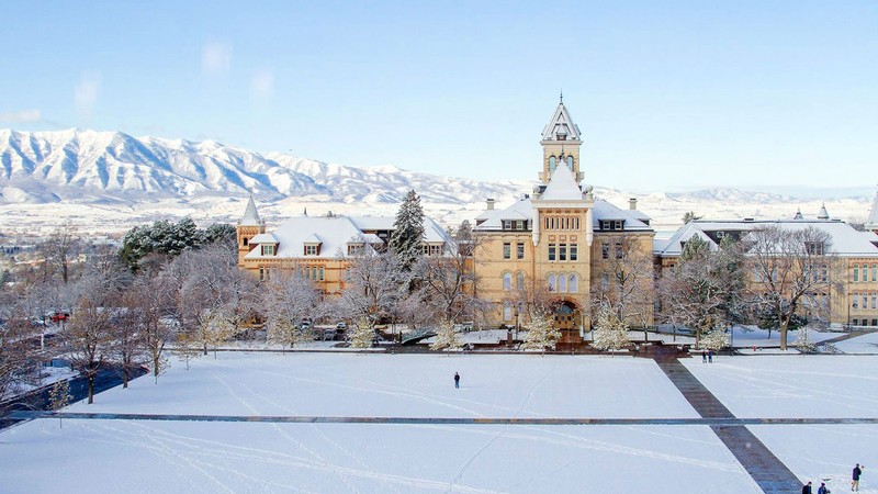 The USU Quad covered in snow with Old Main in the background.