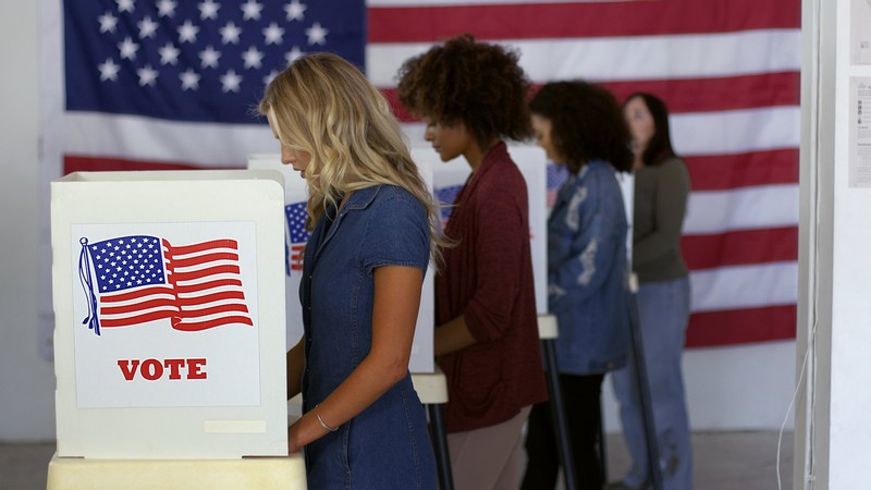Women at a voting booth.