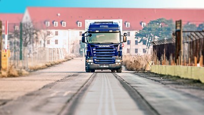 A commercial truck rolling along a test roadway.