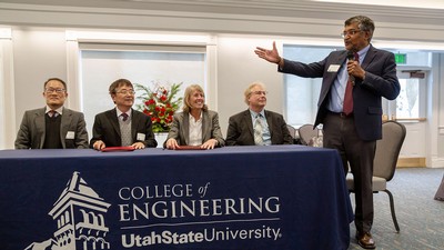 University officials at a table.