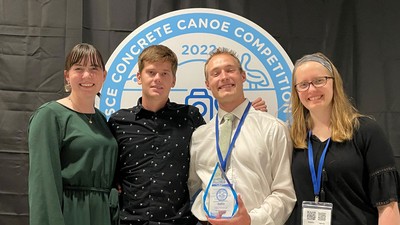 USU Engineering students pose for a photo with a concrete canoe trophy.