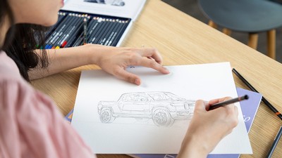 Marium Rasheed sketching a Rivan electric pickup.